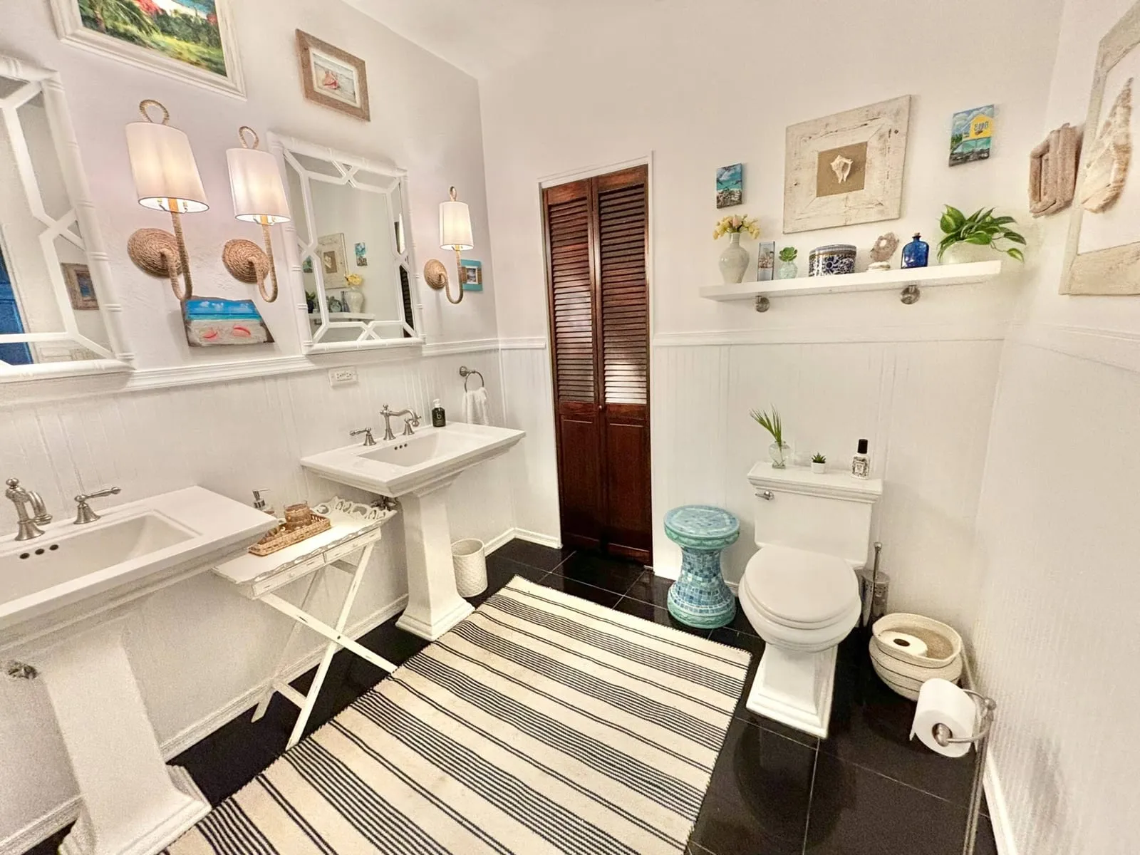 Bathroom with two pedestal sinks and coastal decor