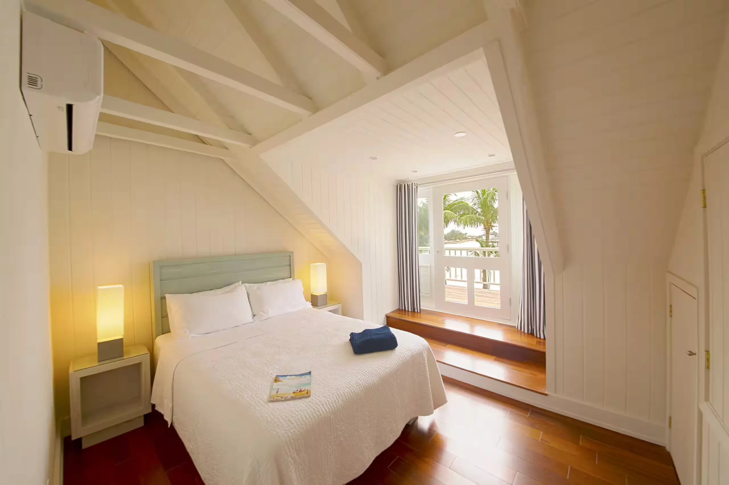 Second bedroom with a blue headboard and its own balcony