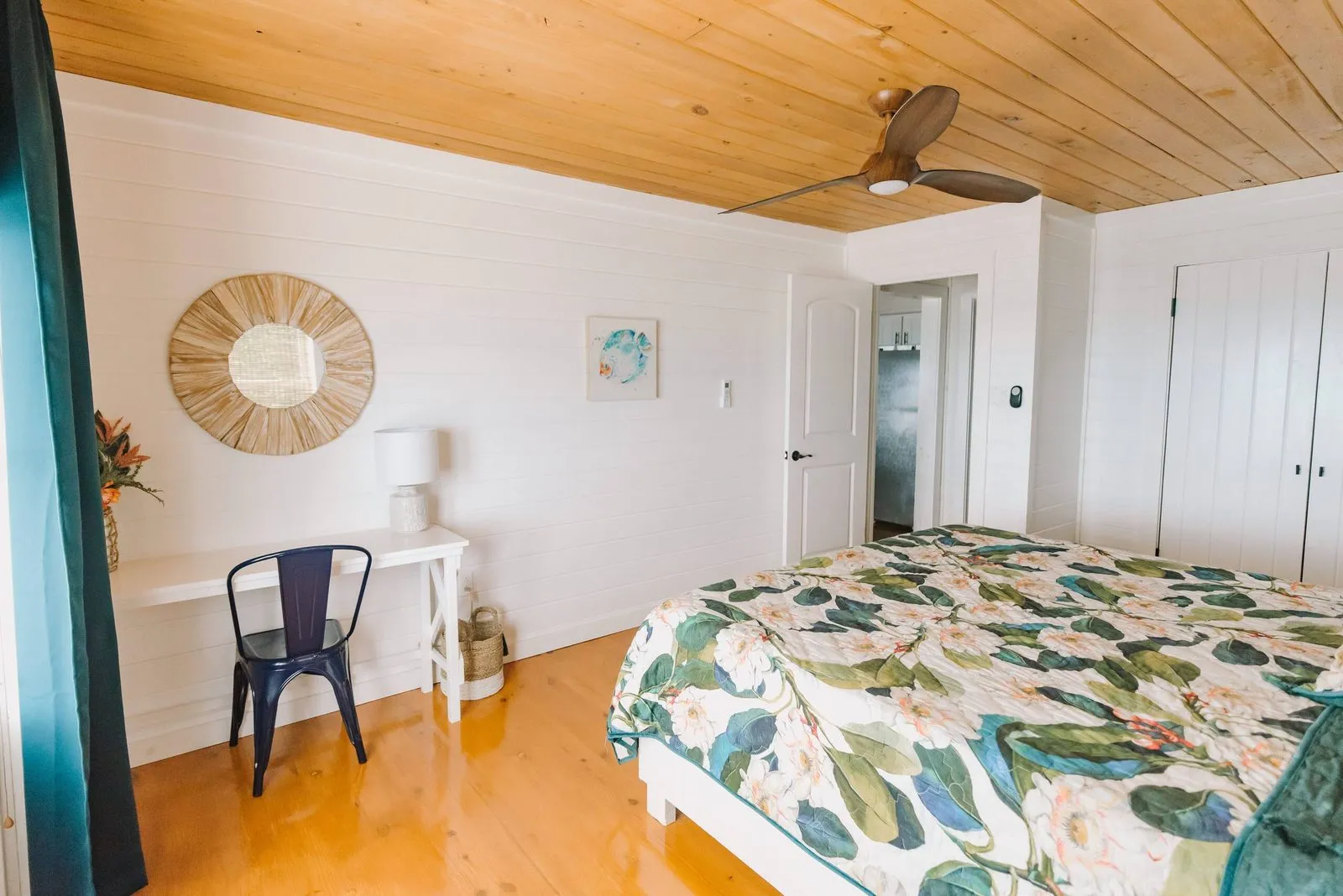 Bedroom with a floral bedspread and reading desk