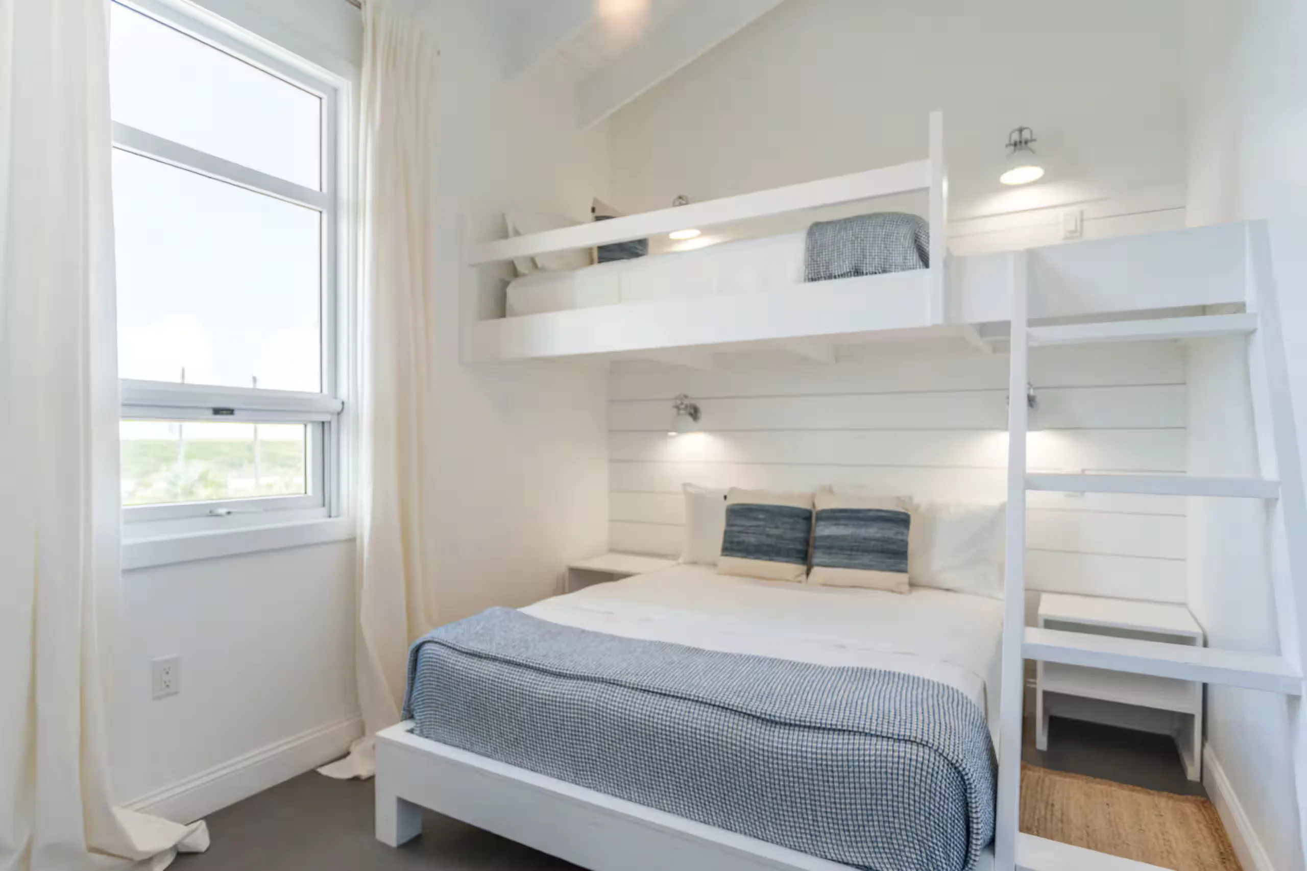 Bedroom with a built-in bunk bed above a queen bed