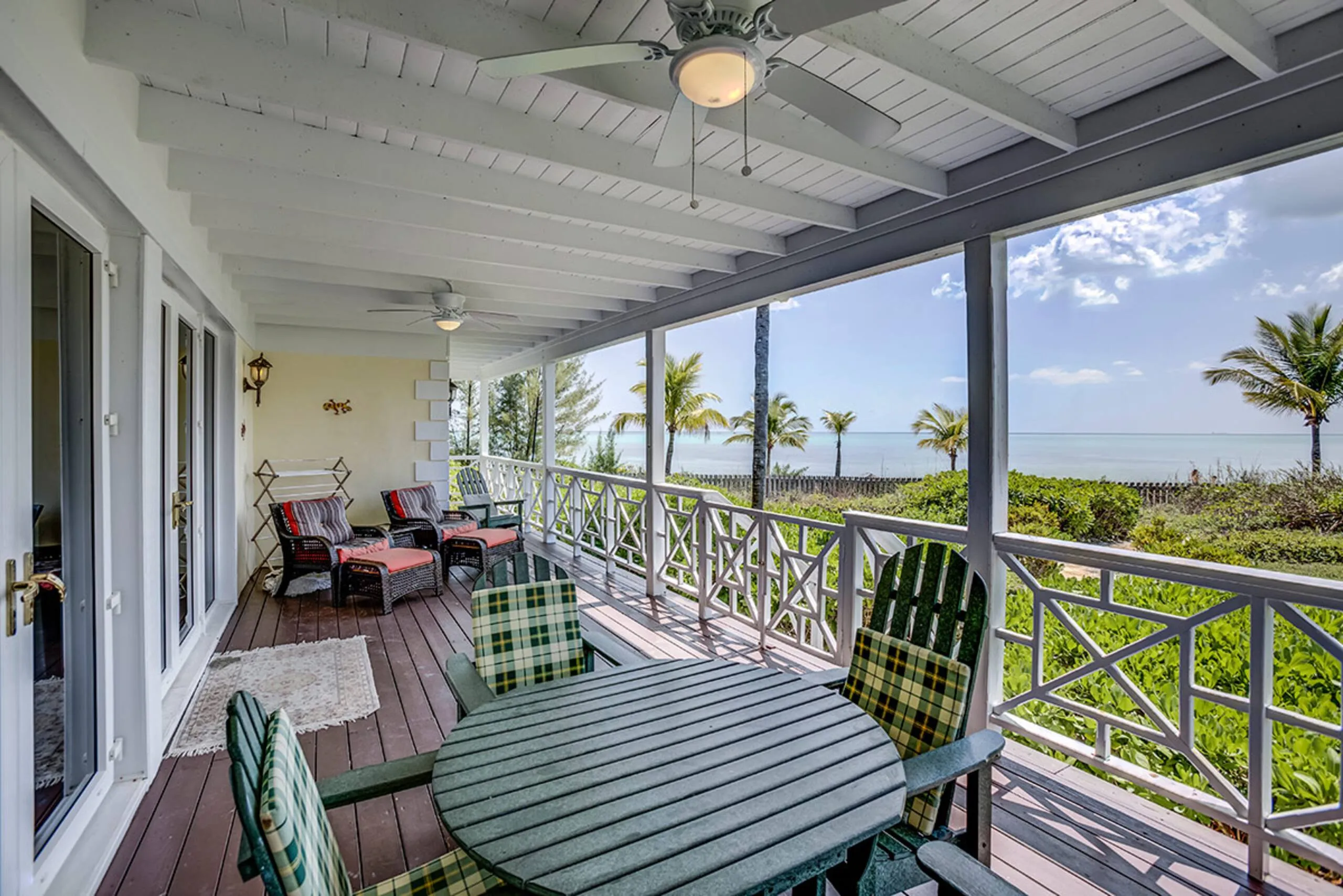 Covered porch with seating overlooking the ocean
