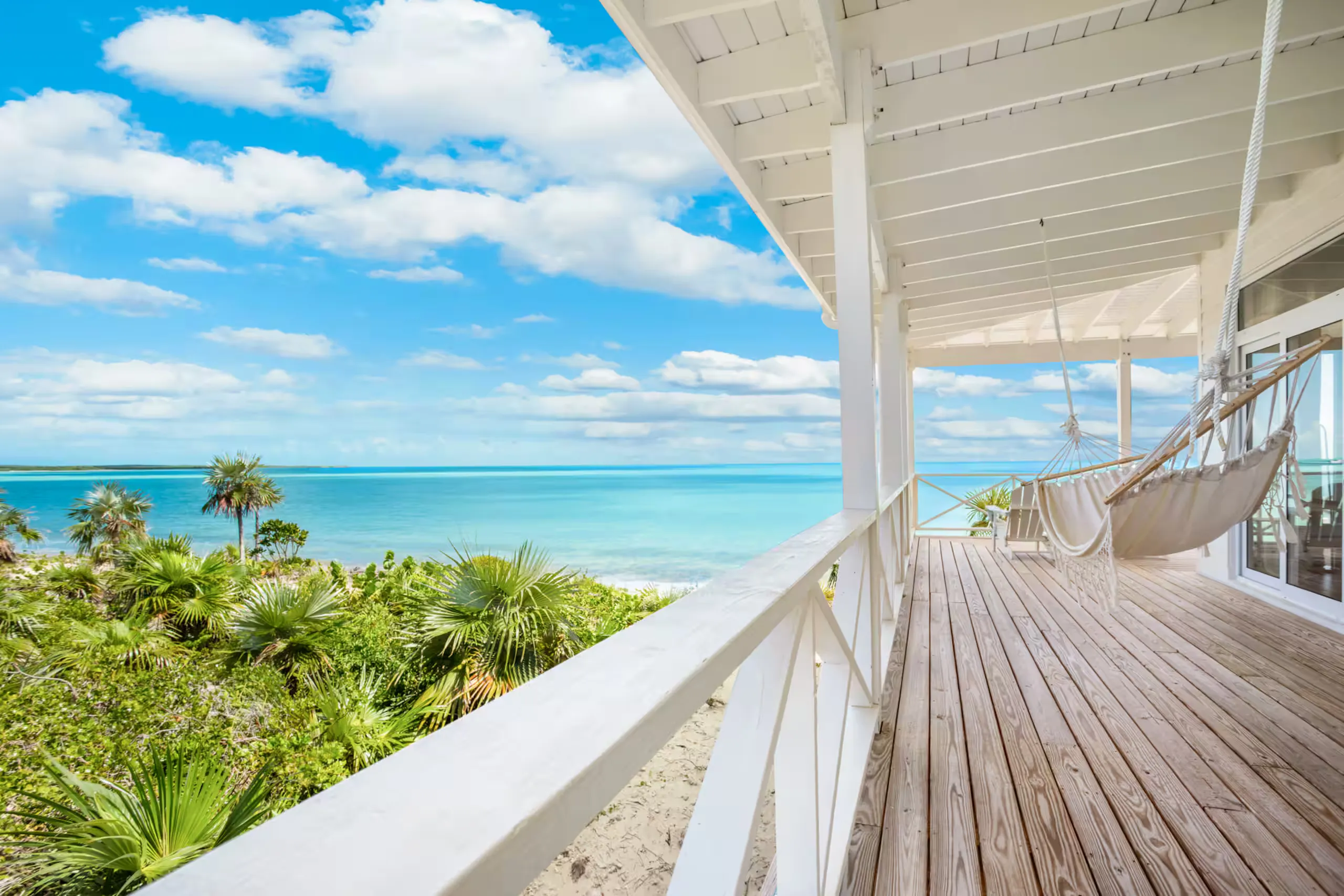 Wrap-around deck with a hanging hammock overlooking the ocean