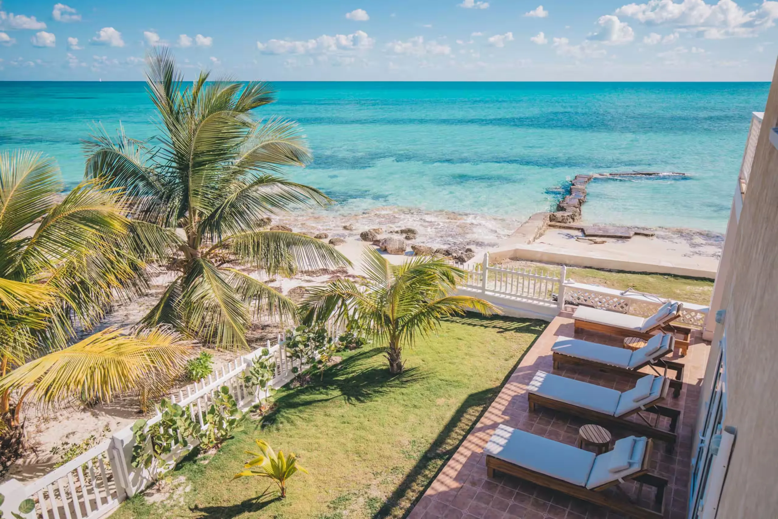 Upper deck with loungers overlooking the ocean and rocky point