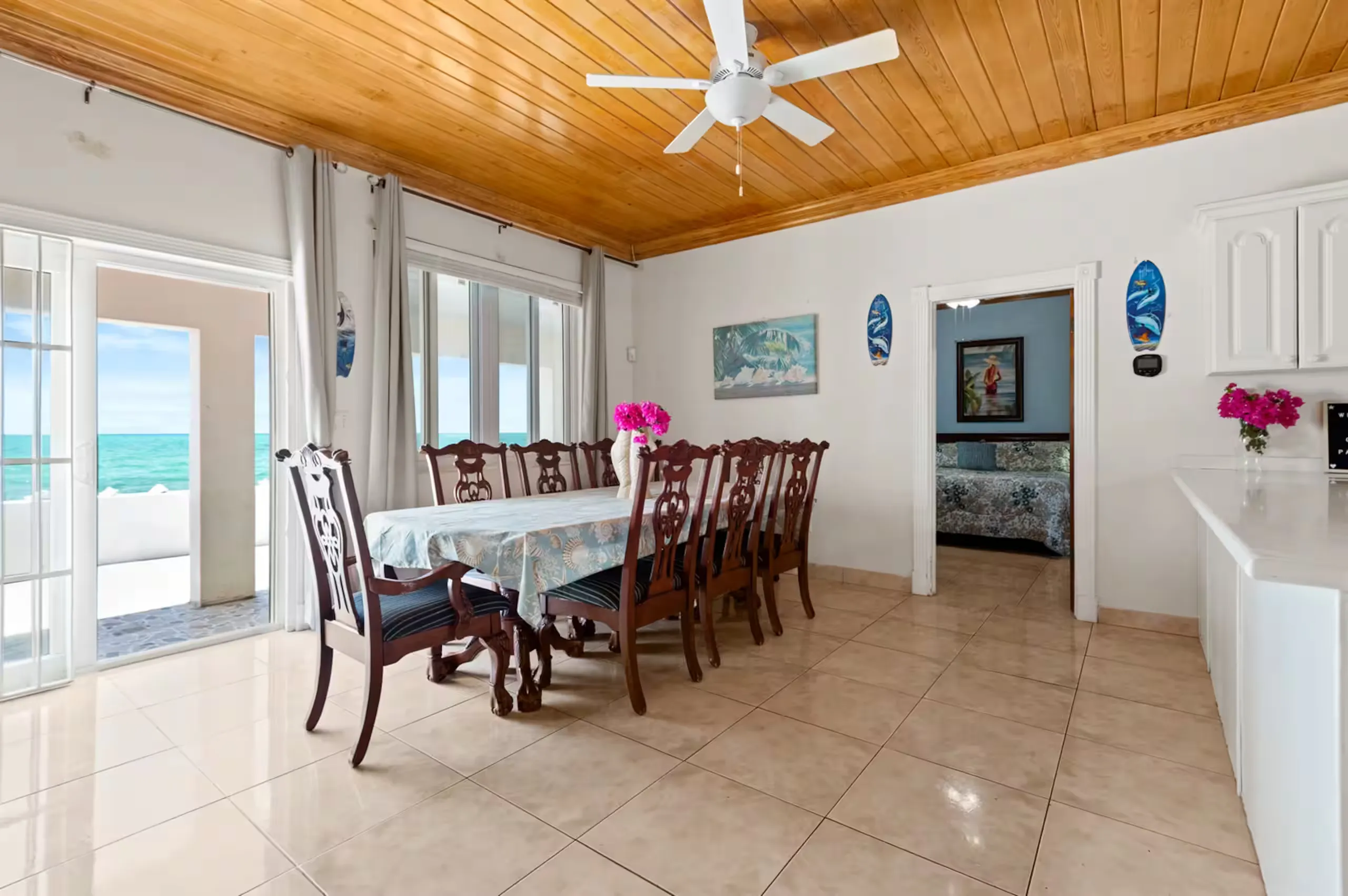 Dining room seating ten, with an ocean view through the doors
