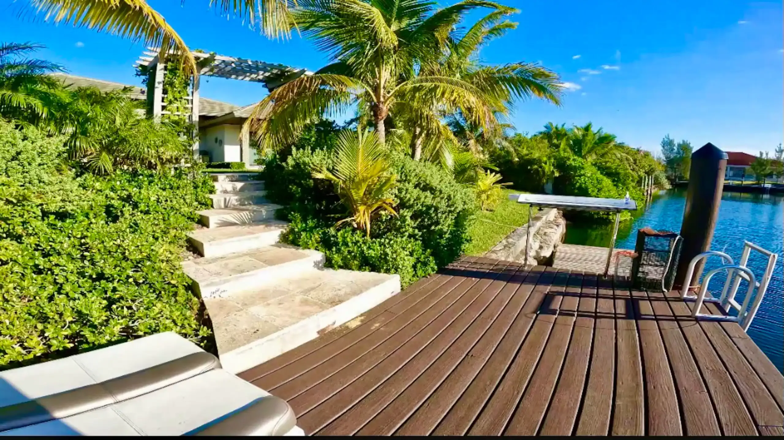 Travertine stairs leading down to the canal-side dock