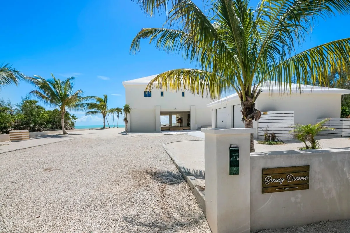 Property entrance with the Breezy Dreams sign and a view through to the water