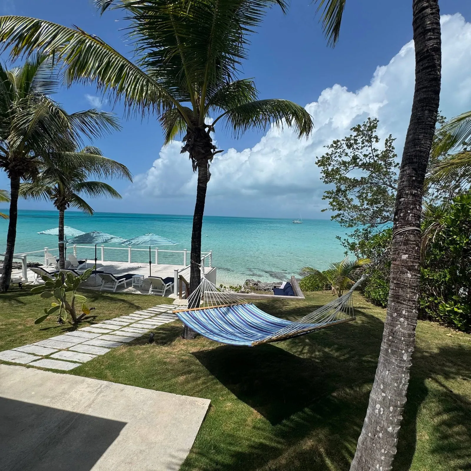 Hammock and stone path leading to the beach and ocean