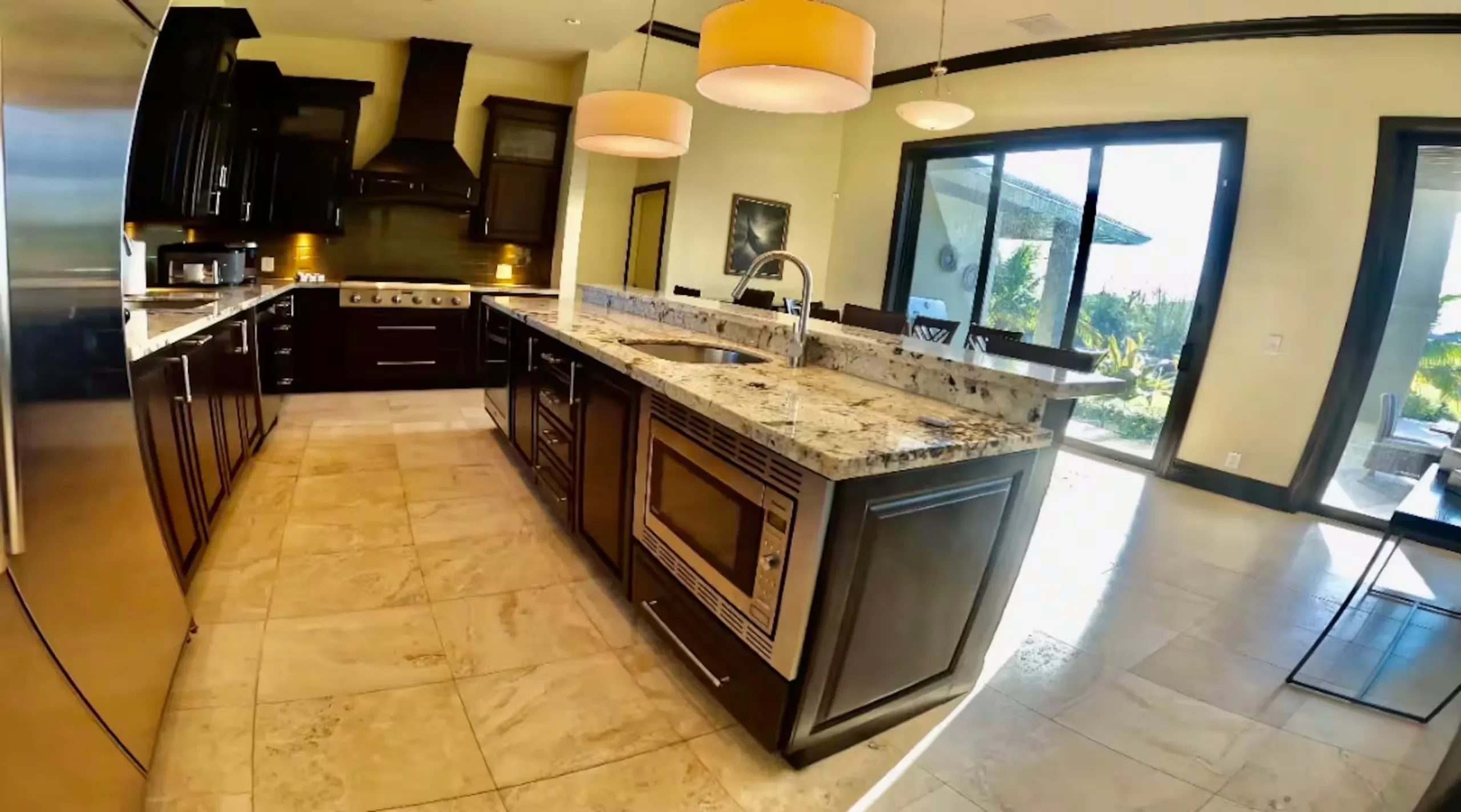 Kitchen with a granite island and a water view through the window