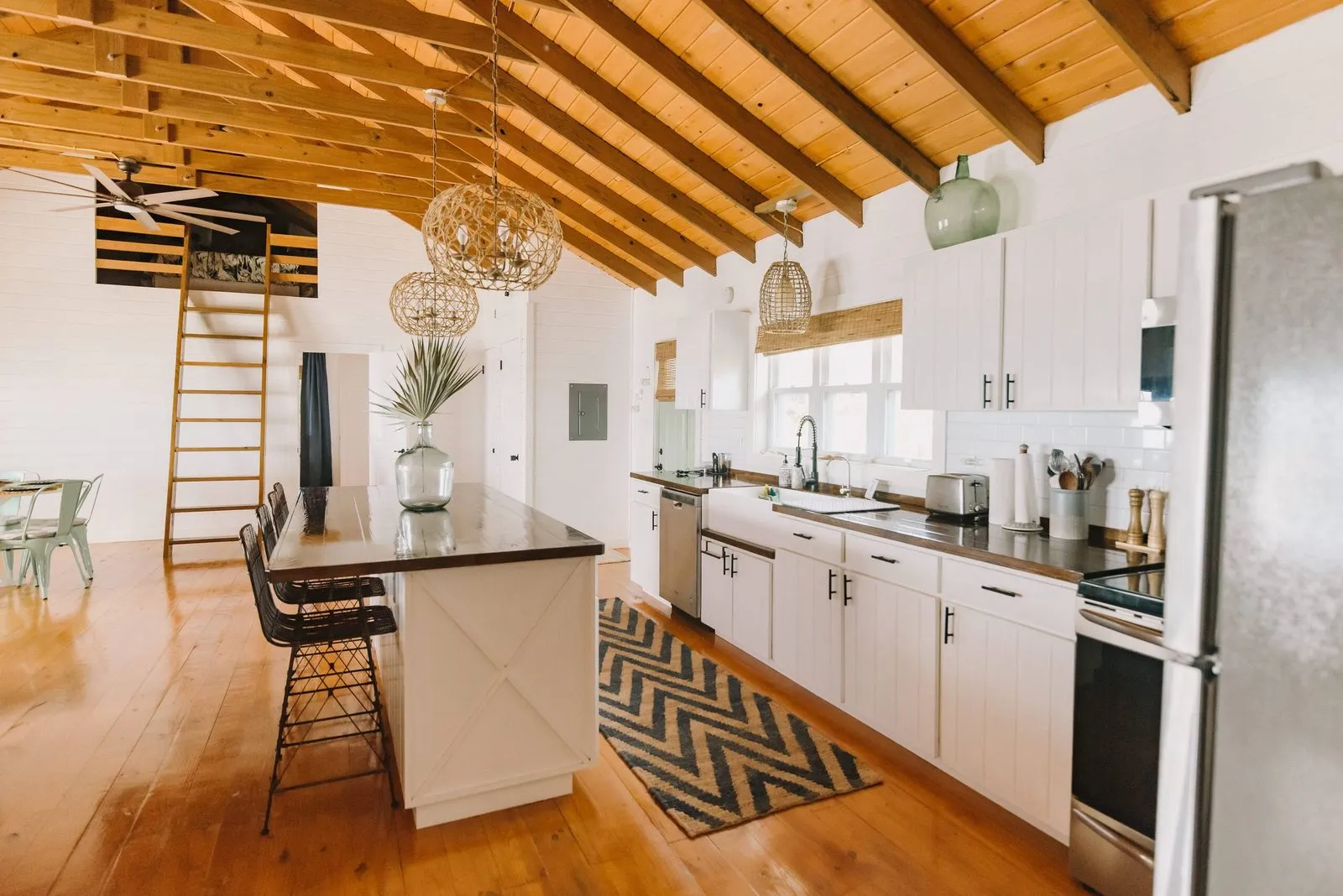 Open-plan kitchen with a wood-beamed ceiling