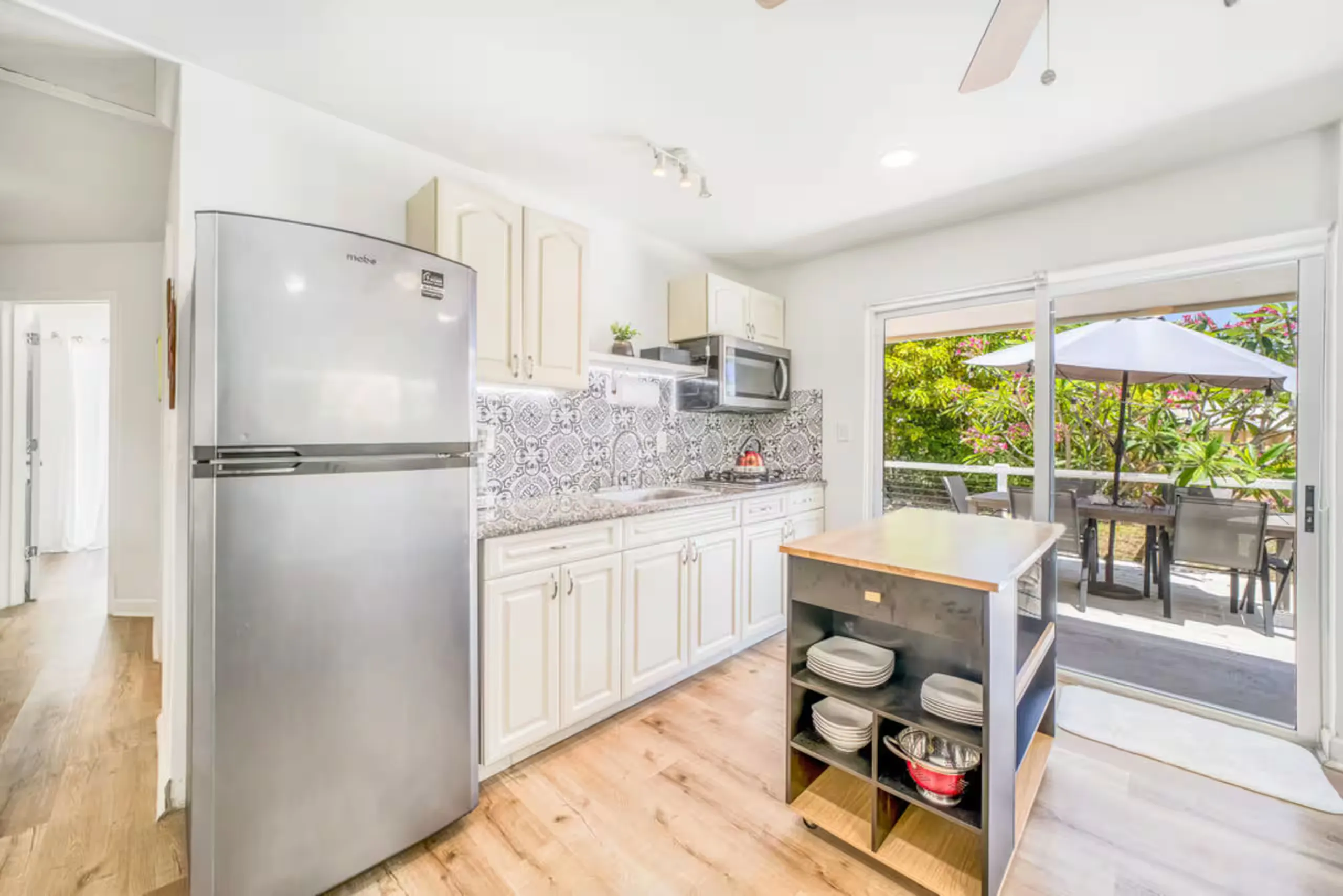 Kitchen with a rolling island and deck access