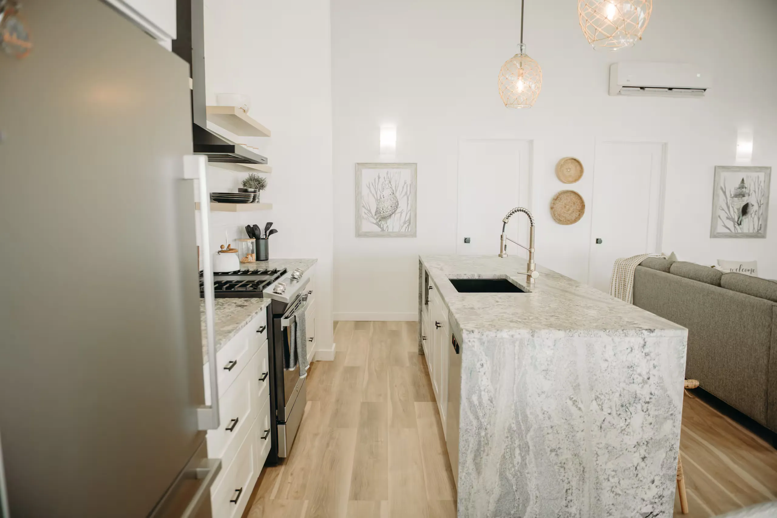 Kitchen with a marble island and pendant lighting