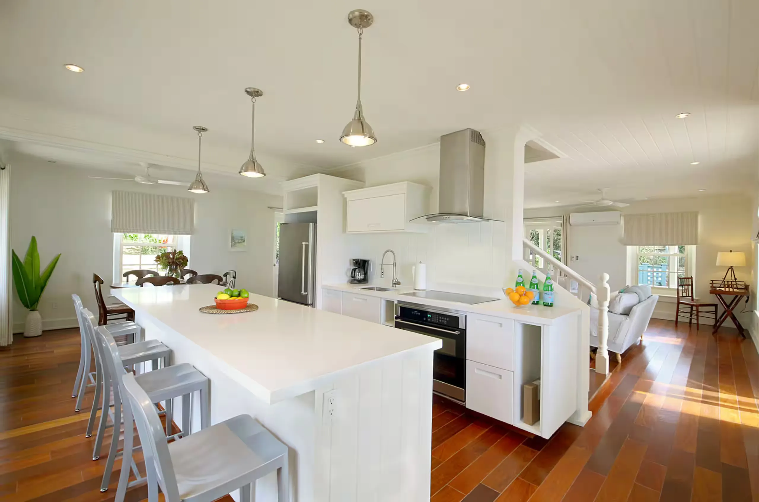 Kitchen with a long white island and pendant lighting