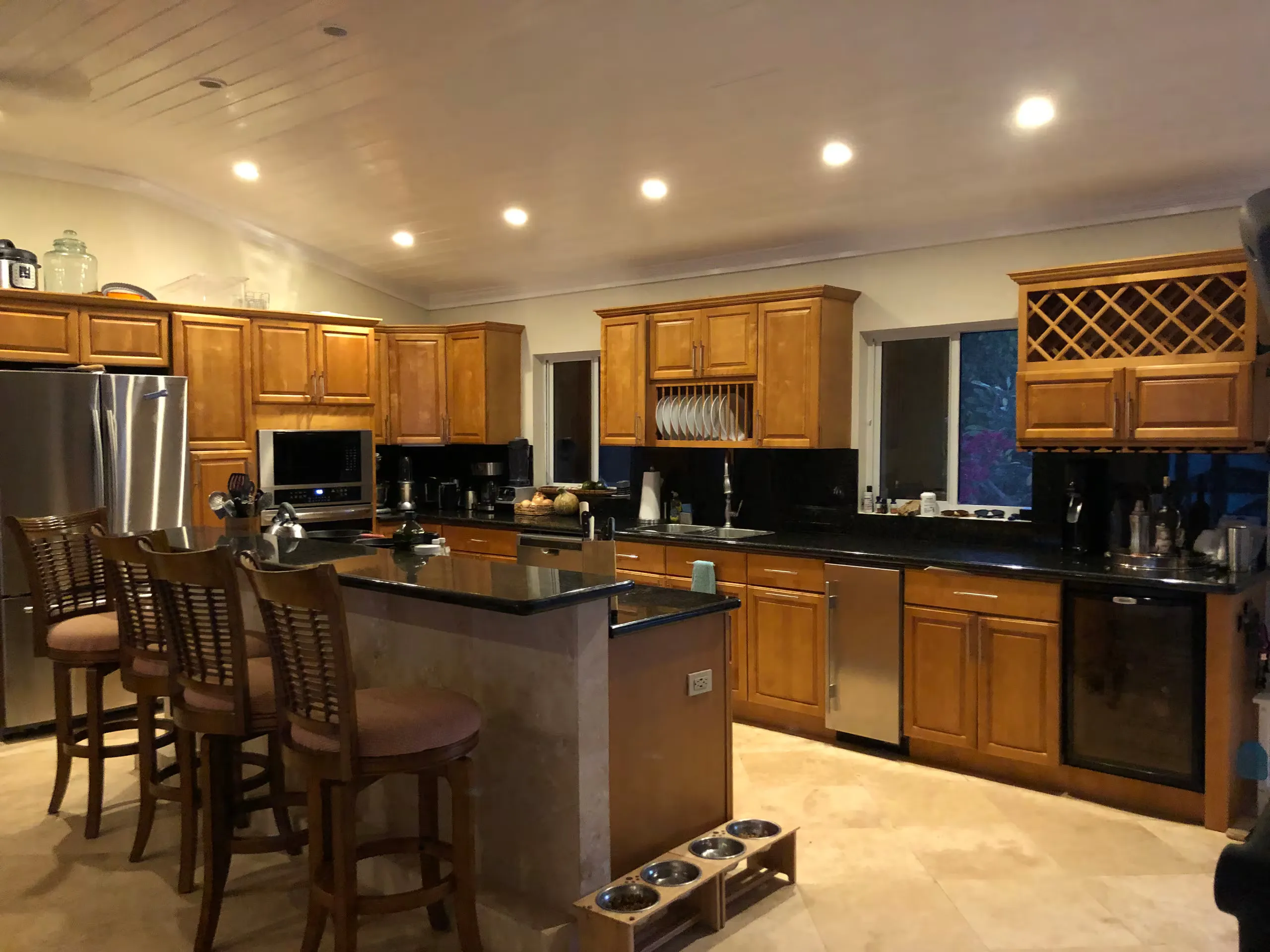 Indoor kitchen with wood cabinetry and a granite island