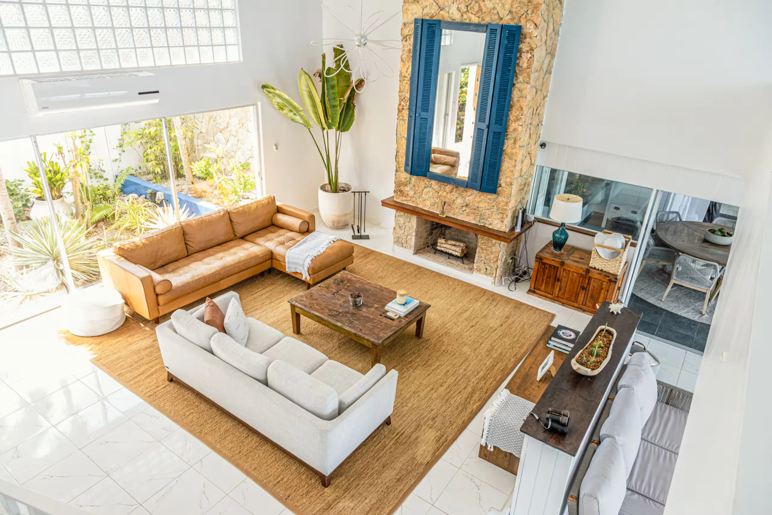 Double-height living room with stone fireplace wall