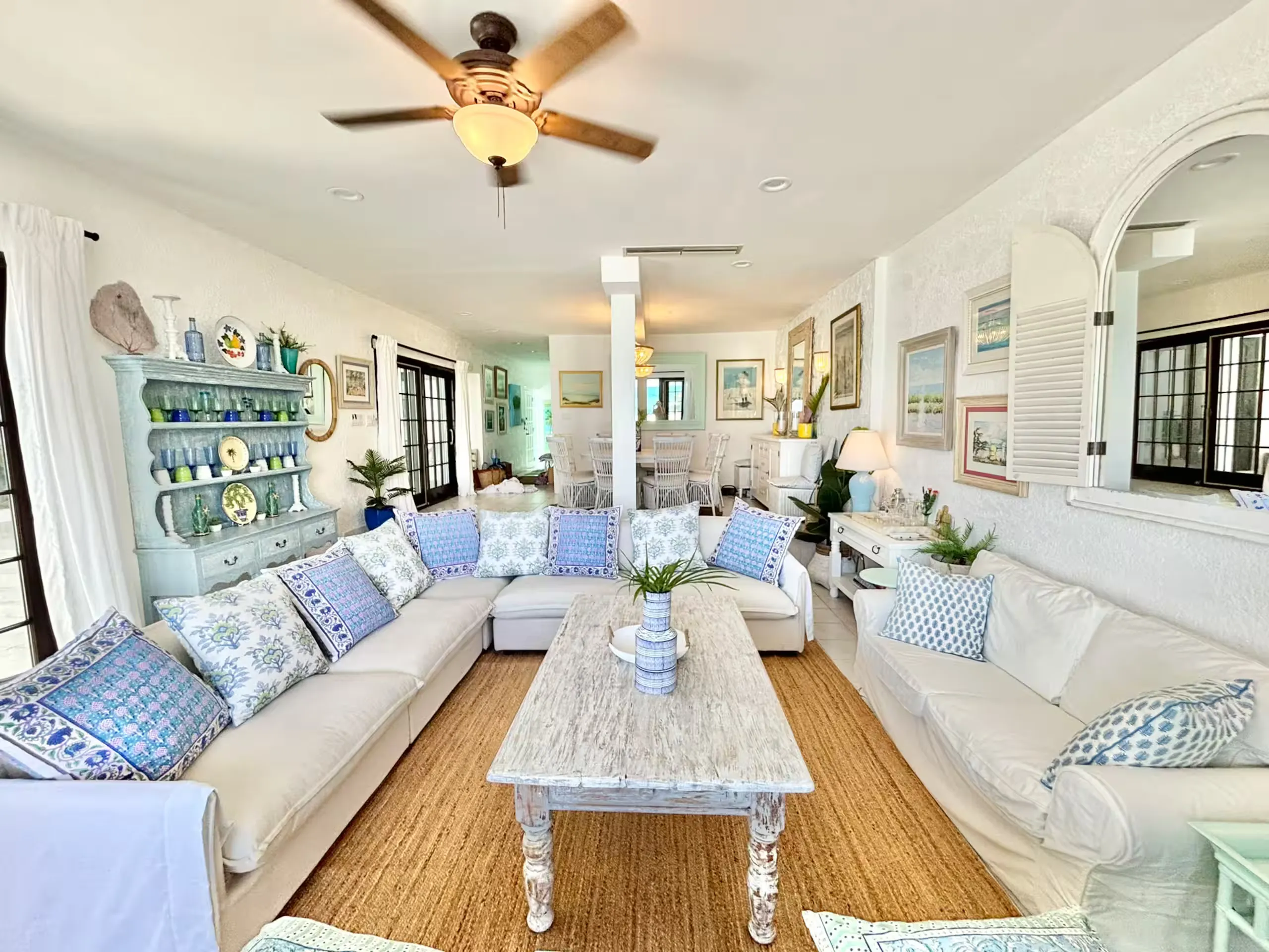 Bright living room with cream sofas and blue coastal pillows