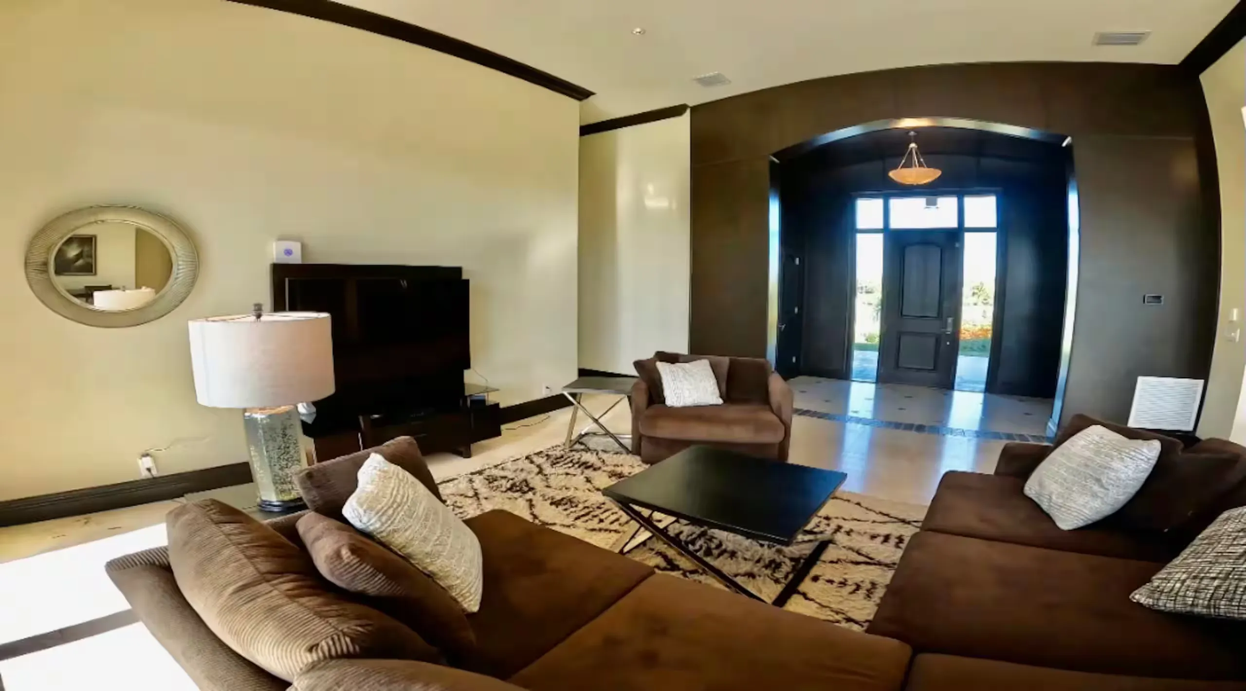 Living room with a sectional sofa and view to the entryway