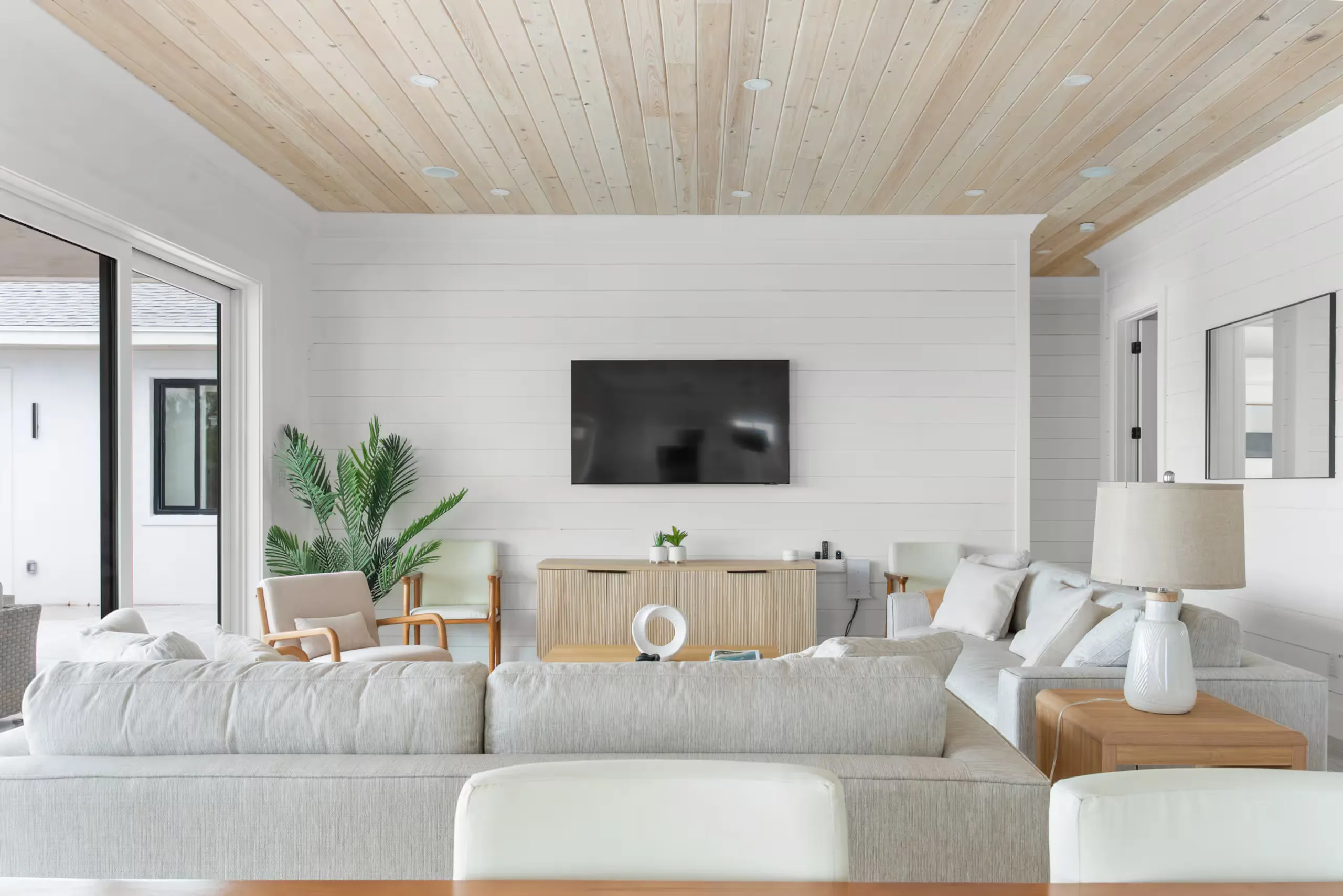 Bright living room with a large sectional and wood ceiling