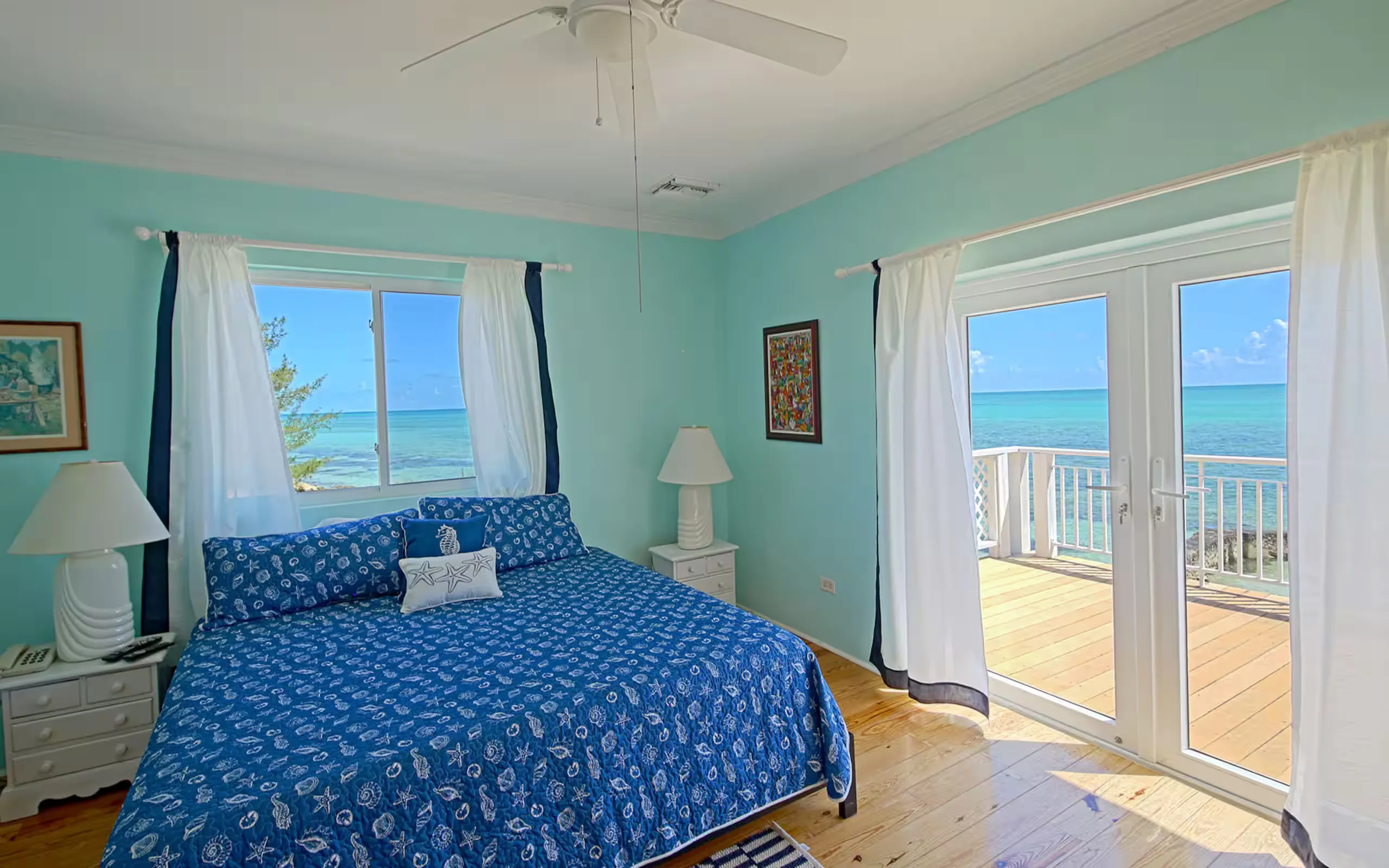 Living room with staircase and ocean-facing doors
