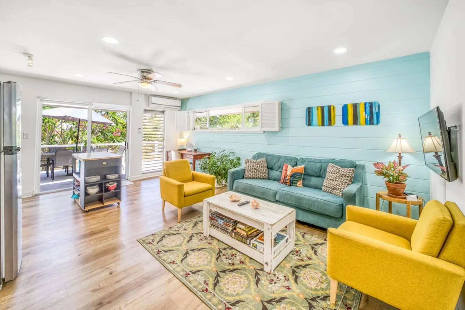 Living room with teal walls and yellow armchairs