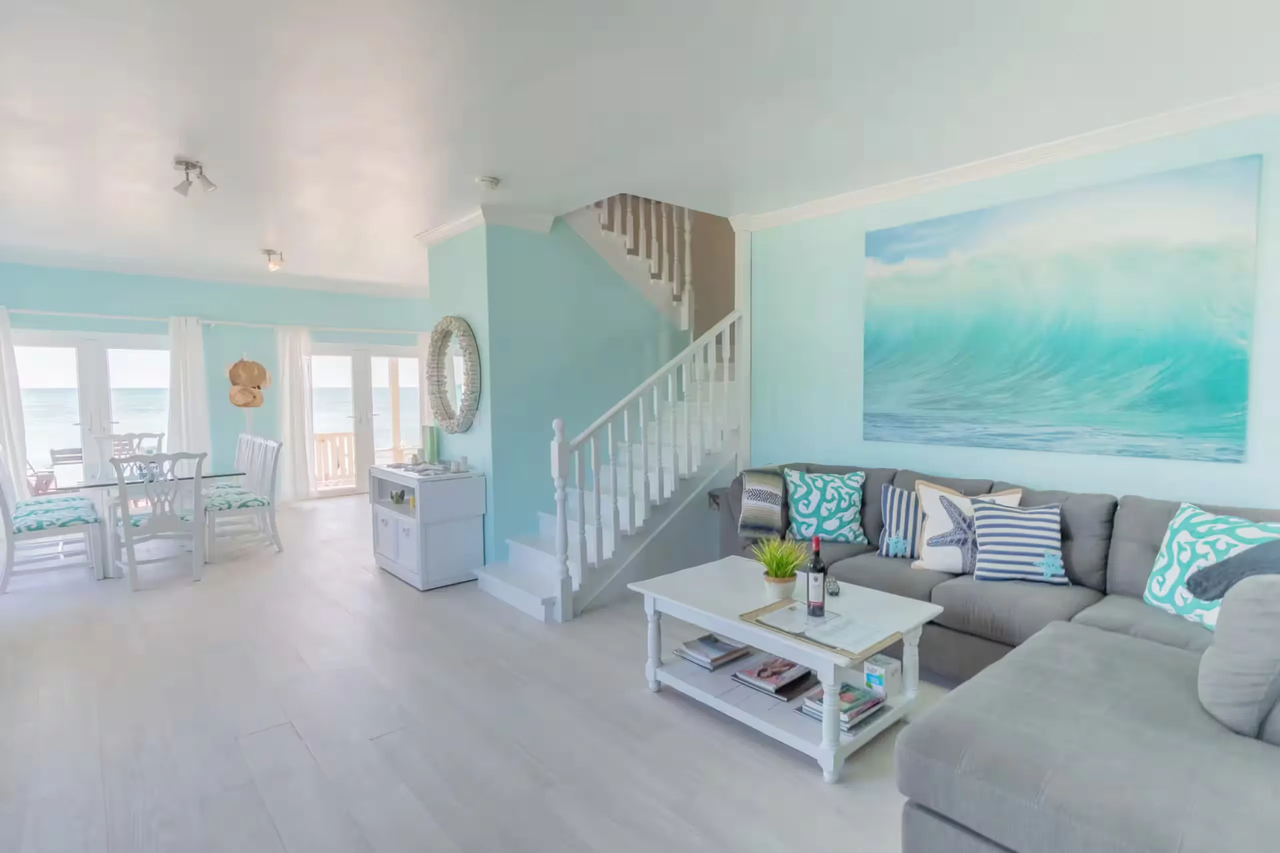 Primary bedroom opening onto an ocean-view balcony