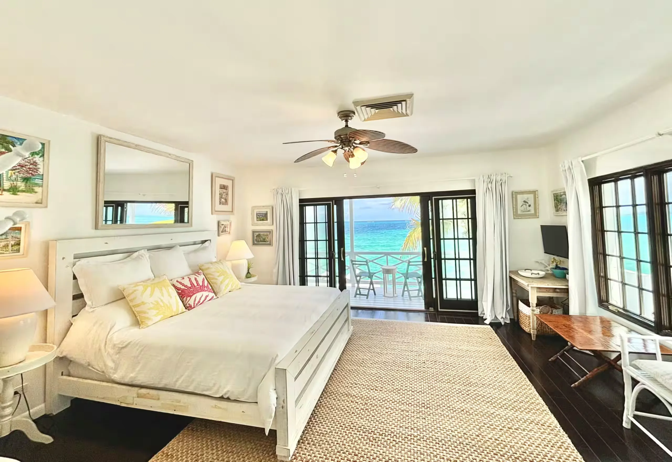 Primary bedroom with sliding doors onto a balcony and ocean view