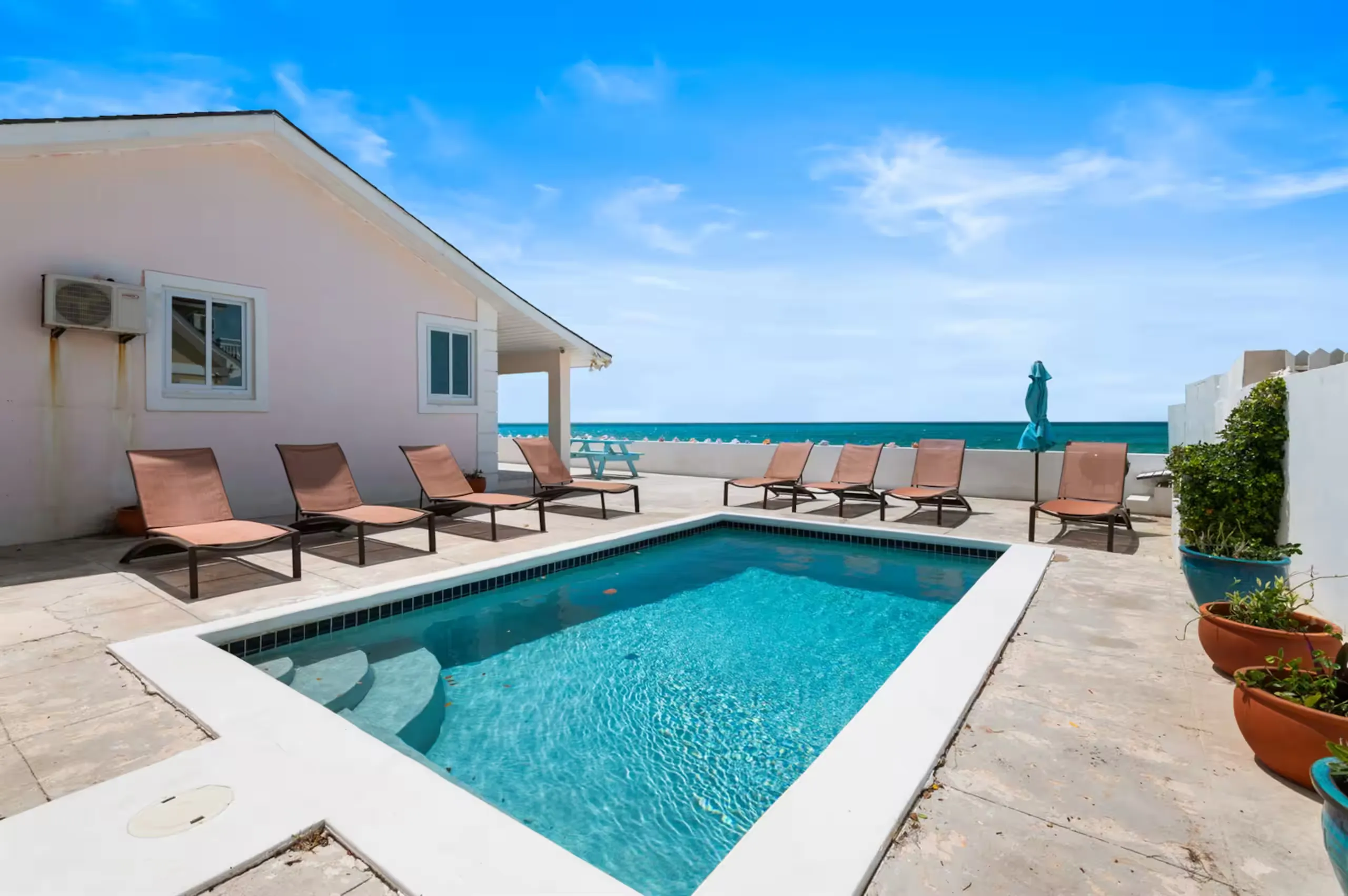 Private pool with lounge chairs facing the ocean