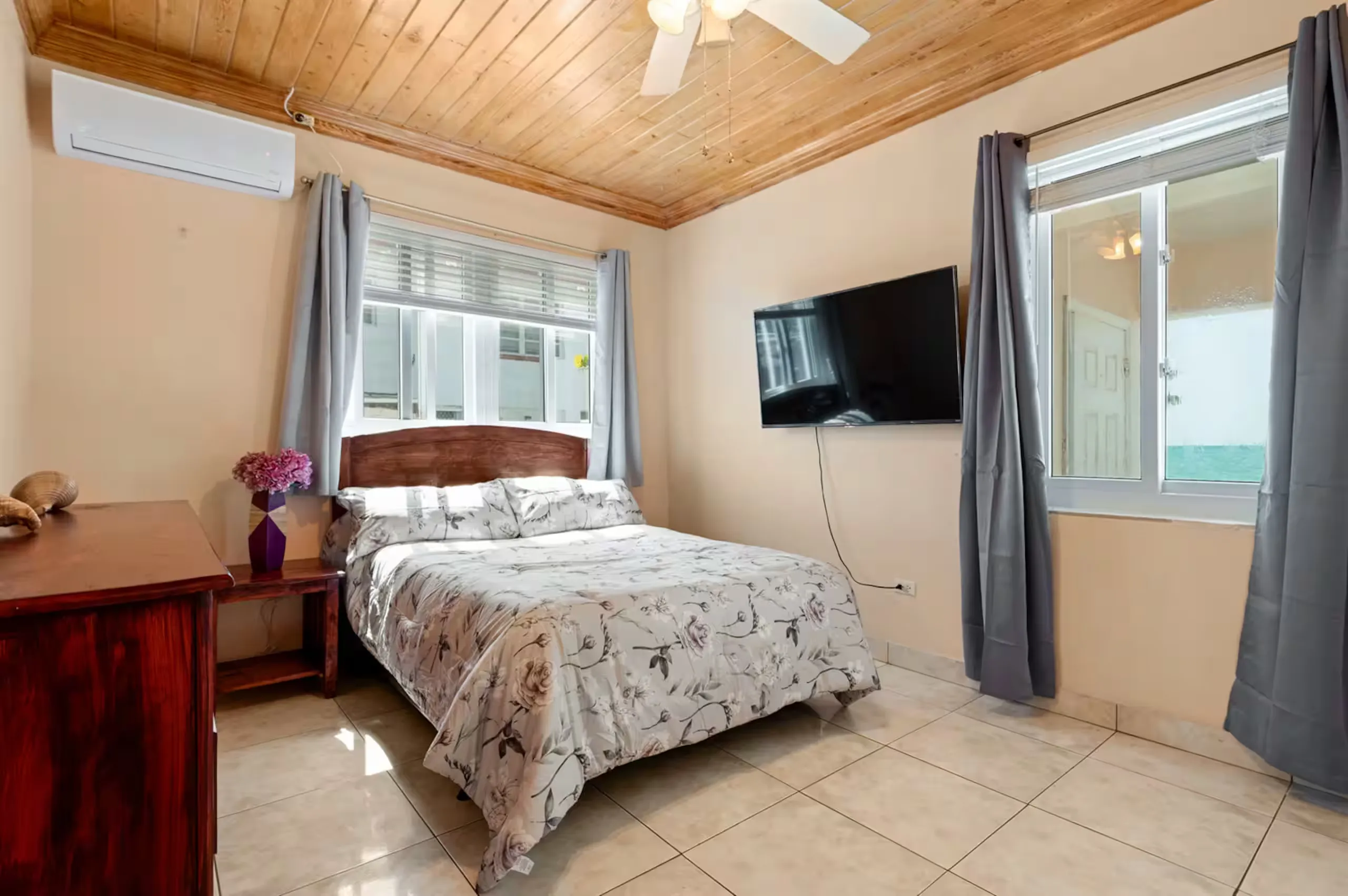Second bedroom with a queen bed and wall-mounted TV