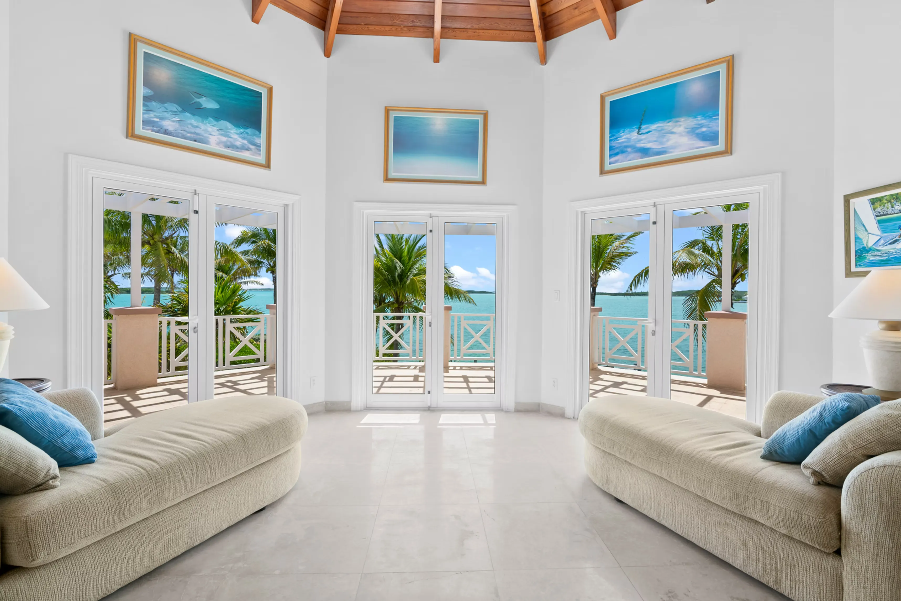 Sunroom opening onto the water through French doors