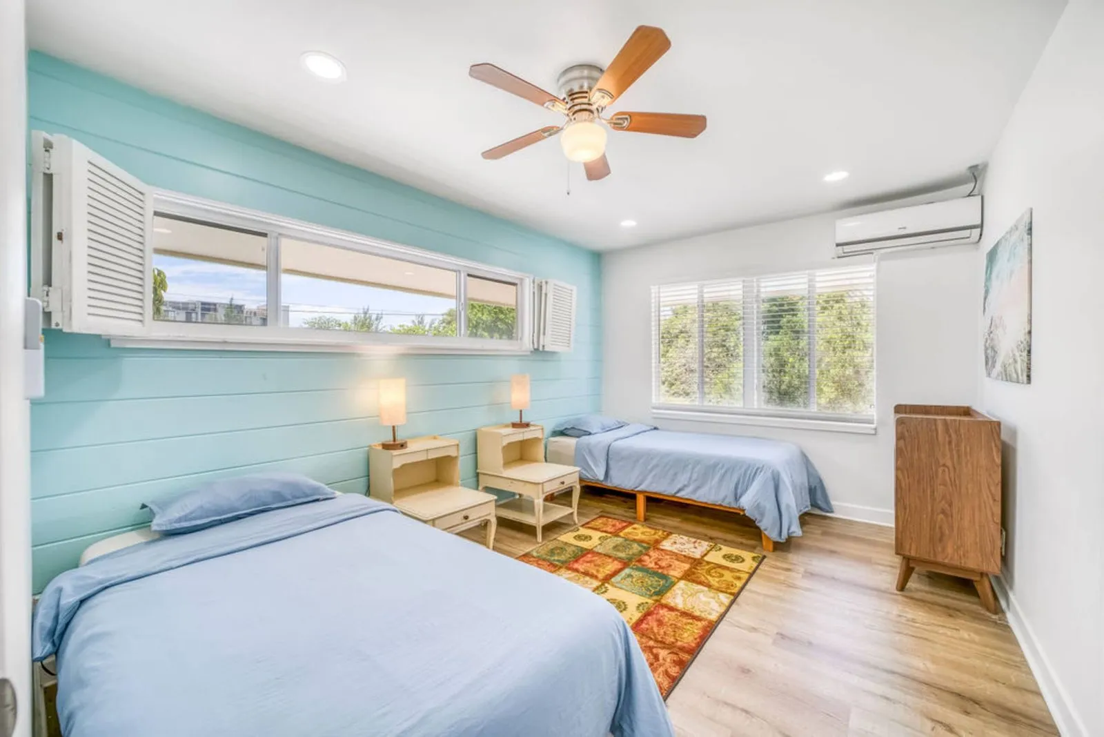 Bedroom with two twin beds and a teal accent wall